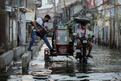 Philippines town gives taxis a lift as floods become norm