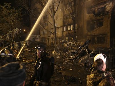 A Russian warplane crashes near an apartment building and kills at least 13