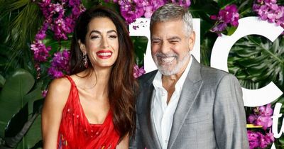 George Clooney lovingly embraces wife Amal as they hit the red carpet in Los Angeles