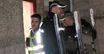 Angry mob descend on Scots street chanting 'beast' as riot cops remove man from flat