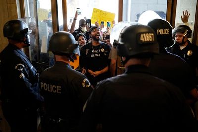 Los Angeles police face off with protesters at City Hall