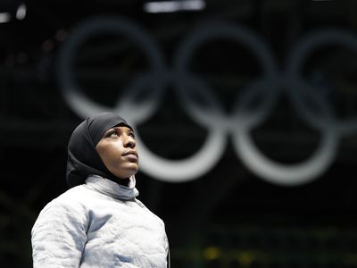 A New Jersey teacher accused of pulling a student's hijab sues an Olympic fencer