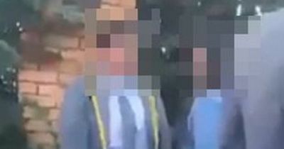 Watch as 'off-duty police officer' attacks boy outside school after splitting up fight