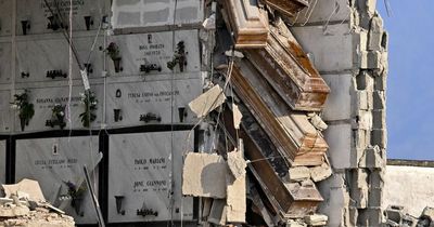 Building suddenly collapses leaving coffins perilously dangling in the air