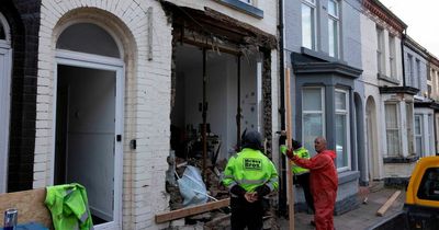 Emergency services surround street as Audi smashes into home