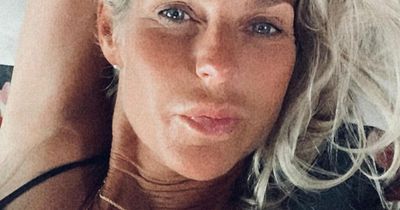 Ulrika Jonsson flashes the peace sign as she shares a sexy selfie from her bed