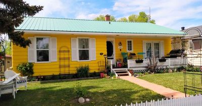 Couple in 'beige' town outrage their neighbours by painting their house bright yellow