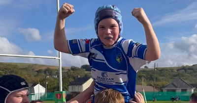 Young boy smaller than everyone in his rugby team held aloft by team-mates after brilliant performance