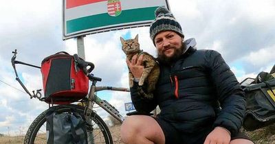 Cat travels through 18 countries on bike after being saved from death by adventurer