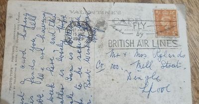 Workman stunned to find hidden 'time capsule' of photos and postcard while ripping out wall