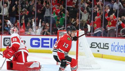 Scrappy Blackhawks rally past Red Wings to win home opener