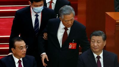 Former Chinese president Hu Jintao escorted out of party congress as Xi Jinping looks on