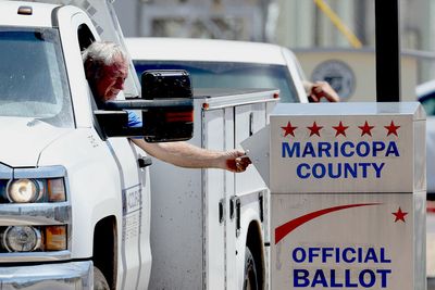 Armed men "watch" ballot drop box in AZ