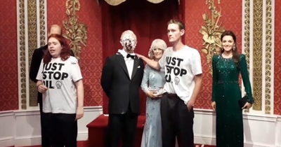 Four arrested after protesters smear chocolate cake over waxwork of King Charles