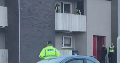 Police swoop on block of Scots flats as man taken to hospital after ‘assault’