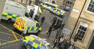 Van flips in Glasgow city centre as man rushed to hospital