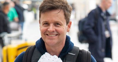 Dec Donnelly all smiles carrying baby son Jack as he heads to Australia for I'm A Celeb