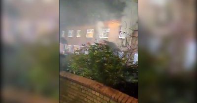 Footage shows building covered in smoke after flat went up in flames