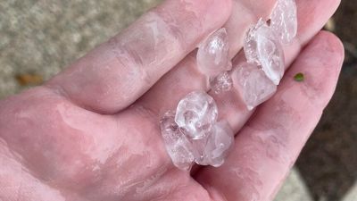 Townsville residents shocked as hail falls over city gripped by extreme heatwave