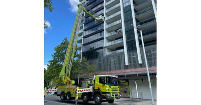 City road reopened after cladding falls from building