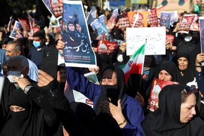 Iran shrine attack mourners chant against Amini 'riots'