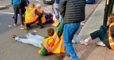 Angry drivers drag Just Stop Oil protesters blocking street out of the road