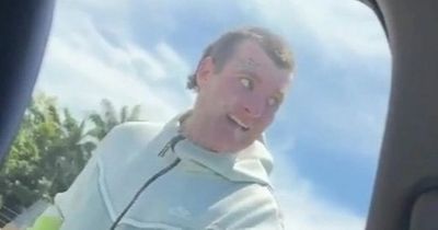 Terrifying moment carjacker armed with MACHETE taps on woman's window with creepy smile