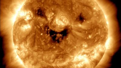 NASA's Solar Dynamics Observatory captures Sun 'smiling' as impacts of meteorite strike recorded on Mars