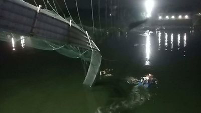 Dozens die in India after cable bridge collapses into river