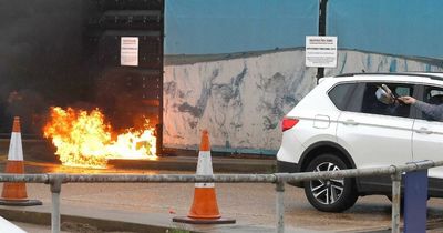 Moment 'laughing' man hurls petrol bomb at immigration centre 'before killing himself'