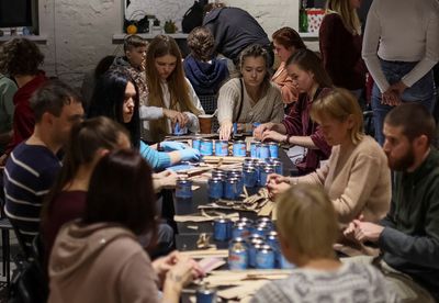 Ukrainian volunteers make 'trench candles' for troops from tin cans