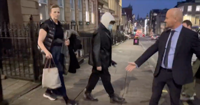 Bonkers moment Bob Dylan serenaded in Glasgow by showbiz reporter as star leaves hotel in hoodie and mask