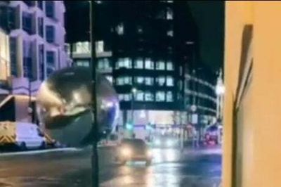 Moment giant bauble artwork rolls after car Indiana Jones-style down Tottenham Court Road