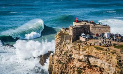 ‘Three times the size of our house’: watching surfers ride Portugal’s monster waves