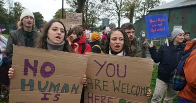 Protestors brave heavy rain to demand closure of refugee detention centre