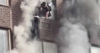 Woman dangles from 20th floor by rope as she's rescued from New York high-rise on fire