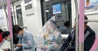 Wuhan subway passenger covers body in huge plastic bag to eat banana amid Covid wave