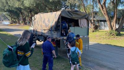 CFA volunteer with ex-military vehicle helping Echuca community traverse floodwaters