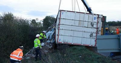 Lorry full of rubbish overturns as men try to clear pile of waste
