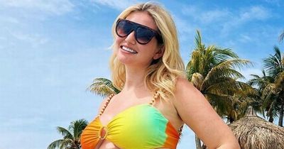 Amy Hart shows off blossoming baby bump in a bikini as she enjoys holiday with boyfriend