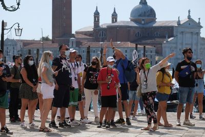 Bustling Venice delays charging tourists for daily visits