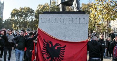 Albanian protesters cover Churchill statue with flag as they demand Home Office apology