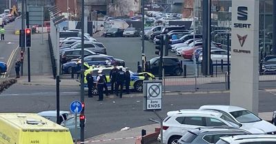 Police vehicle responding to emergency call crashes into car at busy junction