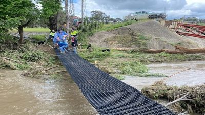 Adelong family builds bridge from power poles after flood washes away only access route