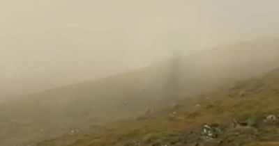 Walker captures 'ghostly figure' hiking alongside him in mountains