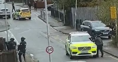 Armed police swarm Cardiff street with weapons pointed at a house