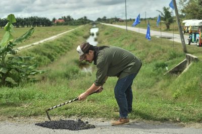 Anti-pothole road warrior revs up Malaysian election race