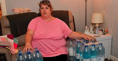 Woman fumes after being stuck with brown water for months as crates of bottled water are sent to her