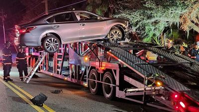 Nissan Altima Driver Can't Resist Car Carrier Ramp, Crashes Near Top