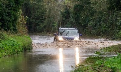 UK weather: roads flooded as heavy rain batters Britain